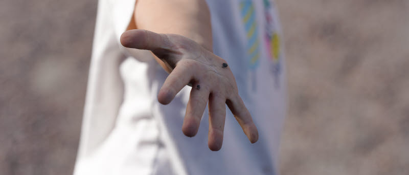 En ung kille sträcker ut sin hand