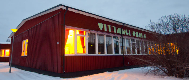 Framsidan på Vittangi skola. Byggnaden är röd och har gröna bokstäver där det står Vittangi skola.